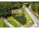 Aerial shot of the community's Stone Creek entrance featuring a waterfall and lush greenery at 7387 Sw 99Th Ct, Ocala, FL 34481