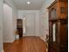 Welcoming entryway featuring wood floors, white walls, and tasteful decorative furnishings at 7387 Sw 99Th Ct, Ocala, FL 34481