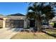 Charming single-story home featuring a two-car garage and a well-maintained lawn at 7387 Sw 99Th Ct, Ocala, FL 34481