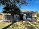 Charming home featuring a well-manicured lawn, palm tree, and neutral stucco exterior at 7387 Sw 99Th Ct, Ocala, FL 34481