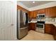 Modern kitchen featuring stainless steel appliances, mosaic backsplash, and neutral countertops at 7387 Sw 99Th Ct, Ocala, FL 34481