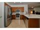 Modern kitchen featuring stainless steel appliances, mosaic backsplash, and neutral countertops at 7387 Sw 99Th Ct, Ocala, FL 34481