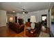 Comfortable living room with hardwood floors, a ceiling fan, and plenty of natural light at 7387 Sw 99Th Ct, Ocala, FL 34481