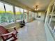 Bright and airy sun room with tiled floor and large windows overlooking the backyard at 7387 Sw 99Th Ct, Ocala, FL 34481