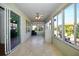 Bright sunroom with tile flooring, ceiling fan, and an abundance of natural light from many windows at 7387 Sw 99Th Ct, Ocala, FL 34481