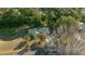 Aerial view of a home featuring a large roof, driveway, and mature trees surrounding the property at 7556 Sw 112Th Ln, Ocala, FL 34476