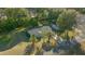 Birds eye view of a home nestled among mature trees, showcasing its roof and surrounding landscape at 7556 Sw 112Th Ln, Ocala, FL 34476