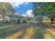 Spacious backyard featuring a well-maintained lawn and verdant landscaping around the home's rear at 7556 Sw 112Th Ln, Ocala, FL 34476