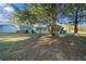 Secluded backyard featuring a well-maintained lawn and verdant landscaping around the home's rear at 7556 Sw 112Th Ln, Ocala, FL 34476