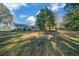 Home's back exterior showcasing a screened patio and mature trees at 7556 Sw 112Th Ln, Ocala, FL 34476