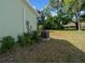 A view of the home's exterior and backyard, showcasing the lawn and trees at 7556 Sw 112Th Ln, Ocala, FL 34476