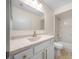 Bright renovated bathroom with marble tiled shower, white vanity and gold accents at 7556 Sw 112Th Ln, Ocala, FL 34476