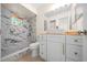 Modern bathroom with decorative tile, updated vanity and walk-in shower with stained-glass window at 7556 Sw 112Th Ln, Ocala, FL 34476