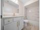 Updated bathroom with marble-style tile, a white vanity with gold fixtures, and a shower-tub combo at 7556 Sw 112Th Ln, Ocala, FL 34476