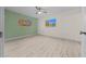 Bedroom with wood-look floors, green accent wall and large window at 7556 Sw 112Th Ln, Ocala, FL 34476