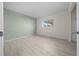 Bedroom featuring wood-look floors, large window and painted accent wall at 7556 Sw 112Th Ln, Ocala, FL 34476