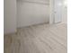Bright bedroom featuring light hardwood floors and a walk-in closet with wire shelving at 7556 Sw 112Th Ln, Ocala, FL 34476