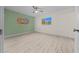 Well-lit bedroom with wood-look floors and two windows at 7556 Sw 112Th Ln, Ocala, FL 34476