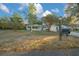 Light green house with a screened porch and attached garage, set back from the road with a spacious yard at 7556 Sw 112Th Ln, Ocala, FL 34476