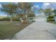 Light green house with a driveway and landscaping at 7556 Sw 112Th Ln, Ocala, FL 34476