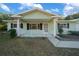 Ranch style home with light green siding, covered porch and landscaped yard at 7556 Sw 112Th Ln, Ocala, FL 34476