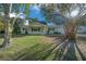 House exterior featuring a light green facade and landscaping at 7556 Sw 112Th Ln, Ocala, FL 34476