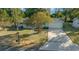 Inviting exterior featuring an attached two-car garage, well-manicured lawn, and picturesque landscaping at 7556 Sw 112Th Ln, Ocala, FL 34476