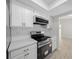 Modern kitchen featuring stainless steel appliances, quartz countertops, white subway tile backsplash, and gold hardware at 7556 Sw 112Th Ln, Ocala, FL 34476