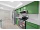 Renovated kitchen featuring stainless steel appliances and green cabinetry at 7556 Sw 112Th Ln, Ocala, FL 34476