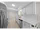 Bright kitchen featuring white cabinetry, gold hardware, stainless steel appliances and wood-look flooring at 7556 Sw 112Th Ln, Ocala, FL 34476