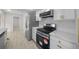 Modern kitchen featuring stainless steel appliances, white cabinets and quartz countertops at 7556 Sw 112Th Ln, Ocala, FL 34476