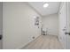 Laundry room with white utility sink and wood-look flooring at 7556 Sw 112Th Ln, Ocala, FL 34476