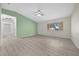 Inviting living room featuring wood floors, green accent wall, and abundant natural light at 7556 Sw 112Th Ln, Ocala, FL 34476