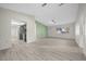 Open-concept living room with light wood-look floors connected to the kitchen at 7556 Sw 112Th Ln, Ocala, FL 34476