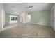Bright living room with light-colored wood floors and green accent walls offers a welcoming atmosphere at 7556 Sw 112Th Ln, Ocala, FL 34476
