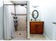 Updated bathroom with walk-in shower, tiled walls, and wood vanity at 7958 Juniper Rd, Ocala, FL 34480