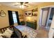 Bedroom with crib, dresser, window, and rustic decor at 7958 Juniper Rd, Ocala, FL 34480