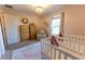 Bright Bedroom featuring two cribs, dresser, and soft rug at 7958 Juniper Rd, Ocala, FL 34480