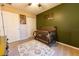 bedroom featuring a crib and green accent wall at 7958 Juniper Rd, Ocala, FL 34480