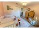 Spacious Bedroom with two cribs, window, and soft rug at 7958 Juniper Rd, Ocala, FL 34480