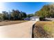 Long driveway leading to a newly built home with a two-car garage at 7958 Juniper Rd, Ocala, FL 34480