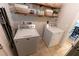 Bright laundry room with washer, dryer, and shelving at 7958 Juniper Rd, Ocala, FL 34480