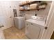 Laundry room with washer, dryer, and shelving at 7958 Juniper Rd, Ocala, FL 34480