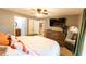 Main bedroom with king-size bed and access to ensuite bathroom and laundry at 7958 Juniper Rd, Ocala, FL 34480