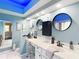 Spa-like bathroom with a double vanity, large mirrors, and blue accent walls at 8476 Sw 108Th Place Rd, Ocala, FL 34481