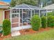 Private screened enclosure surrounded by lush greenery at 8476 Sw 108Th Place Rd, Ocala, FL 34481