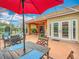 Relaxing screened patio with seating area, fire pit, and dining table at 8476 Sw 108Th Place Rd, Ocala, FL 34481