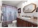 Bathroom with dark wood cabinets and a shower/tub combo at 8677 Sw 95Th Ln # F, Ocala, FL 34481