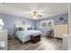 Spacious main bedroom with king bed, light blue walls, and wood-look floors at 8677 Sw 95Th Ln # F, Ocala, FL 34481