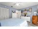 Serene bedroom with light blue walls and a ceiling fan at 8677 Sw 95Th Ln # F, Ocala, FL 34481